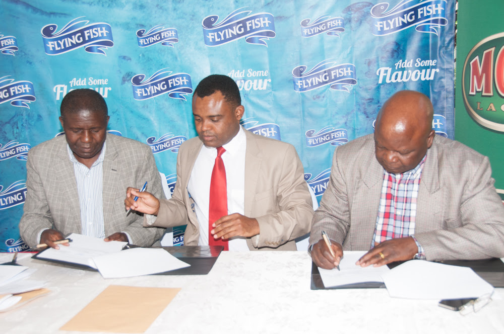 From left, Lusaka Province Liquor Traders Association (LPLTA) Secretary General Expendito Chipalo, Zambian Breweries Director of Corporate Affairs Ezekiel Sekele and Lusaka Province Liquor Traders Association President David Nseluka sign an MOU to encourage responsible drinking.