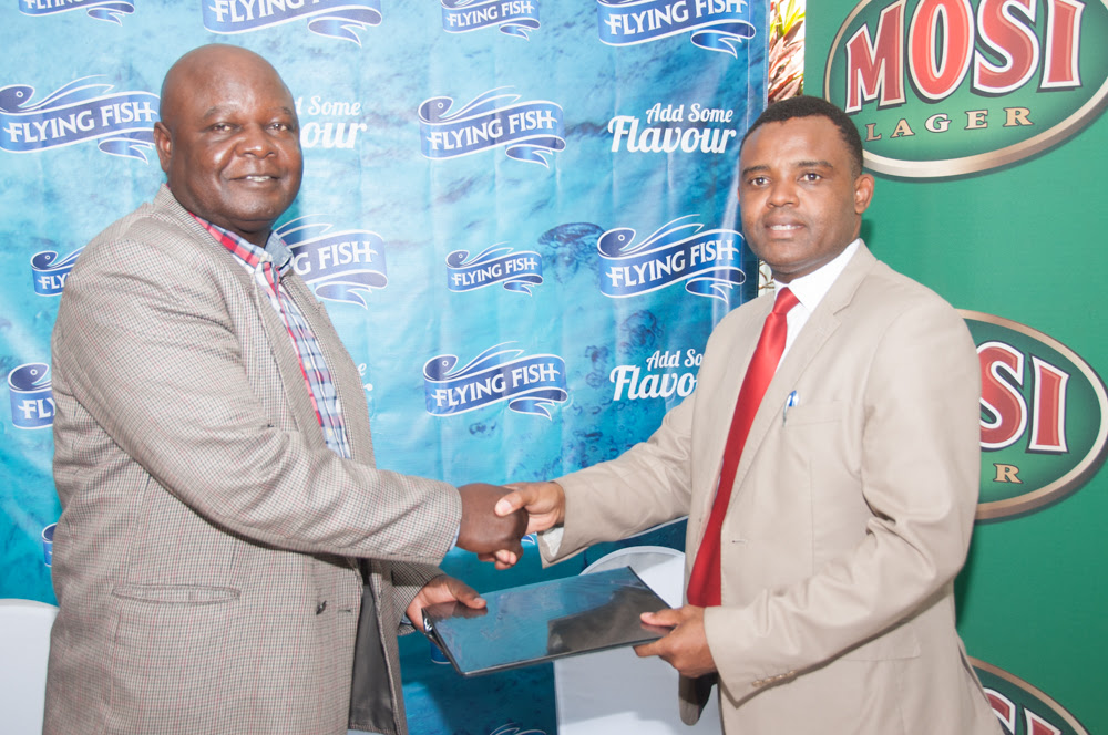 Zambian Breweries Director of Corporate Affairs Ezekiel Sekele (left) and Lusaka Province Liquor Traders Association President David Nseluka agree an MOU to encourage responsible drinking.