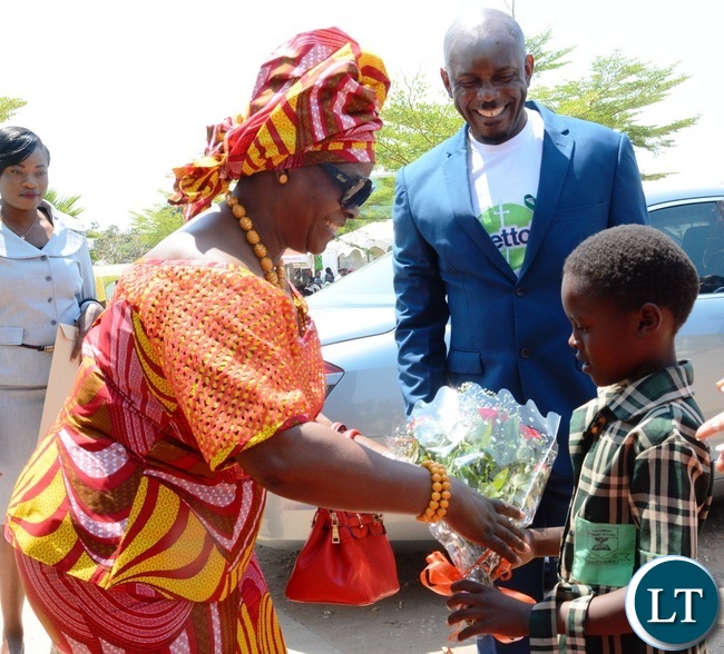 First Lady Esther Lungu(l) being welcomed by a Grade One pupil of North mead Primary School Natasha Namukwanya(r) at Giacomo Global Hand Washing Day at North mead Primary School