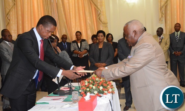 President Edgar Lungu(l) swears in Freedom Sikazwe(r) as Presidential Affairs Minister of State House during the Swearing in Ceremony at State House