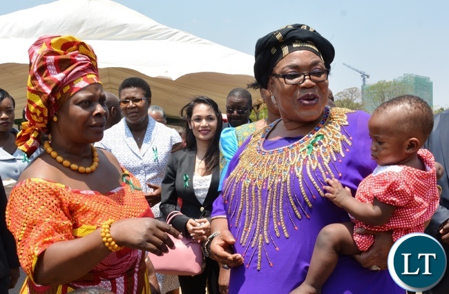First Lady Esther Lungu(l) chats with former first Lady Vera Tembo Chiluba(r) and her grandchild Safira during Giacomo Global Hand Washing Day at North mead Primary School