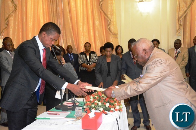 President Edgar Lungu(l) swears in Freedom Sikazwe(r) as Presidential Affairs Minister of State House during the Swearing in Ceremony at State House