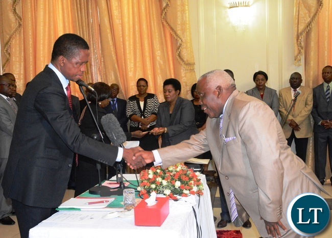 President Edgar Lungu(l) congratulates the newly appointed Minister of Presidential Affairs(State House) Freedom Sikazwe(r) during the Swearing in Ceremony at State House