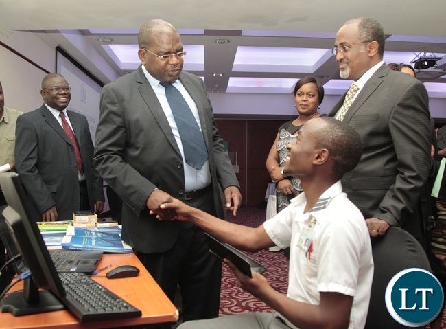 Health Minister Chitalu Chilufya chats with E-learning student nurse of Kitwe Mwaba Zulu whilst Child fund Reginal Director Victor Koyi (l) and Child fund Zambia National Director Dereje Adugna (r) looks on during the launch of the roll out of E-learning as a training Methodology in Zambia Health Minister Chitalu Chilufya chats with E-learning student nurse of Kitwe Mwaba Zulu whilst Child fund Reginal Director Victor Koyi (l) and Child fund Zambia National Director Dereje Adugna (r) looks on during the launch of the roll out of E-learning as a training Methodology in Zambia