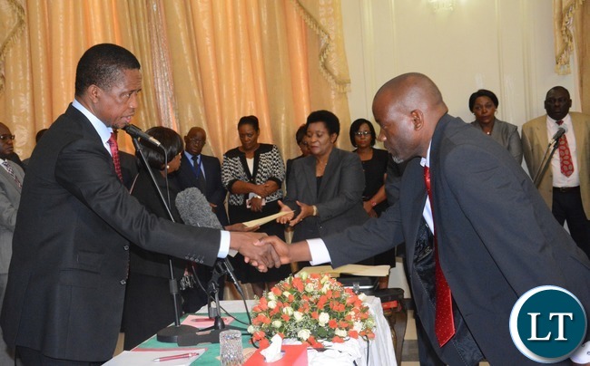 President Edgar Lungu(l) congratulates newly appointed Minister of Water and Sanitation Loyd Kaziya during the Swearing in Ceremony