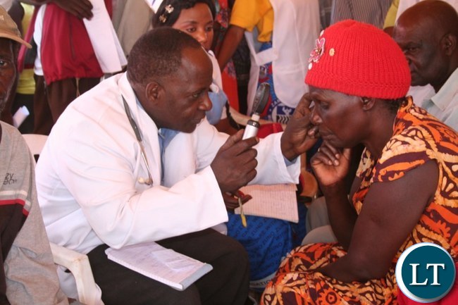 The Ministry of Health in partnership with ORBIS with funding from Standard Chartered Bank organized a free eye screening, provision of spectacles and drug campaign in Solwezi on Thursday. Above, an eye specialist George Chipeta from Solwezi Urban clinic (l) screening Christine Kamuyutwa from Highland compound at Kyawama grounds on Friday as Nurse Dorcas Mulenga(m) looks on The Ministry of Health in partnership with ORBIS with funding from Standard Chartered Bank organized a free eye screening, provision of spectacles and drug campaign in Solwezi on Thursday. Above, an eye specialist George Chipeta from Solwezi Urban clinic (l) screening Christine Kamuyutwa from Highland compound at Kyawama grounds on Friday as Nurse Dorcas Mulenga(m) looks on