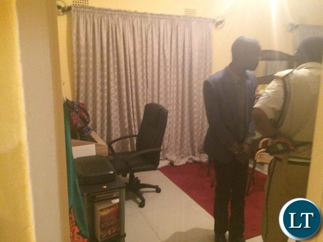 Police officers combing the bedroom