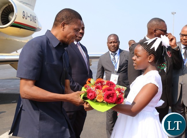 President Edgar Lungu receives a bouquet from a 10 year old Lukundo Nachilongo at Luanda international airpot in Angola 26-10-2016