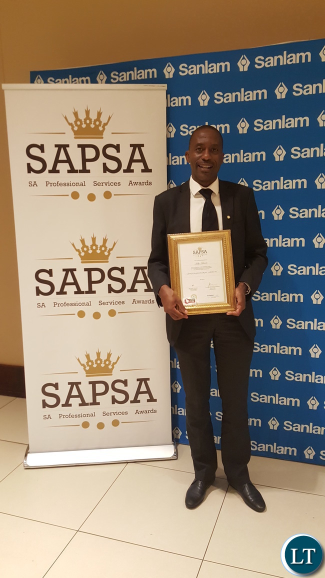 Mr. Kelly Kalumba shows off his certificate after he was nominated as one of the finalists for the Professional of the Year in the ‘Architecture Class of the Built Environment’ category