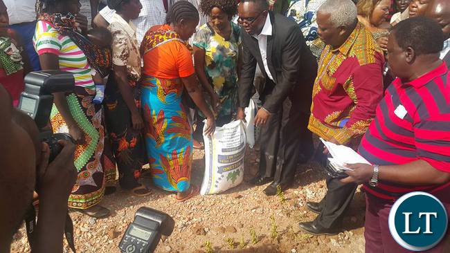 Bwana Mukuba MP Dr.Chanda hands mealie meal to victims of the storm as Minister for Presidential affairs Freedom Sikazwe looks on.