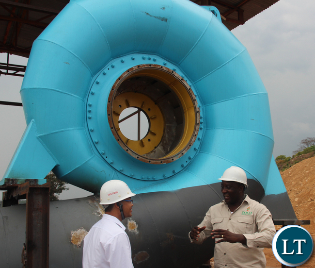 Sinohydro project Manager Mr Ying Feng Zeng shows Zesco spokesperson Henry Kapata the new turbine to be installed at the new Musonda Falls Power station. The Musonda falls power station is being upgraded from 5 to 10 Mega Watts. Sinohydro project Manager Mr Ying Feng Zeng shows Zesco spokesperson Henry Kapata the new turbine to be installed at the new Musonda Falls Power station. The Musonda falls power station is being upgraded from 5 to 10 Mega Watts. Picture By Jean Mandela