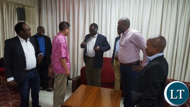 Ministers chatting with Chinese officials shortly before departure