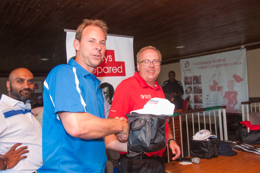 Paratus sales executive Andrew Shaw presents a golf prize to a lucky winner.