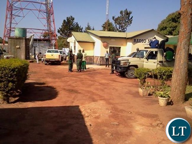 Police officers outside Radio Mano