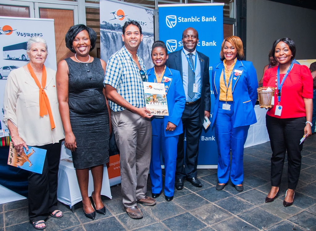 Proflight Marketing Manager Hellen Ngwira Mwamba, second right, and Commercial Development Analyst Mwate Van-Rietvelde, centre, with draw winner Andre Tennekoon, centre, along with Stanbic Bank Zambia Chief executive Charles Mudiwa, third right, Stanbic Head of Personal and Business Banking Mukwandi Chibeskunda, second left, Voyagers Manager Molly Care, left, and Stanbic Public Relations and Communications Manager Chanda Chime-Katongo, right.
