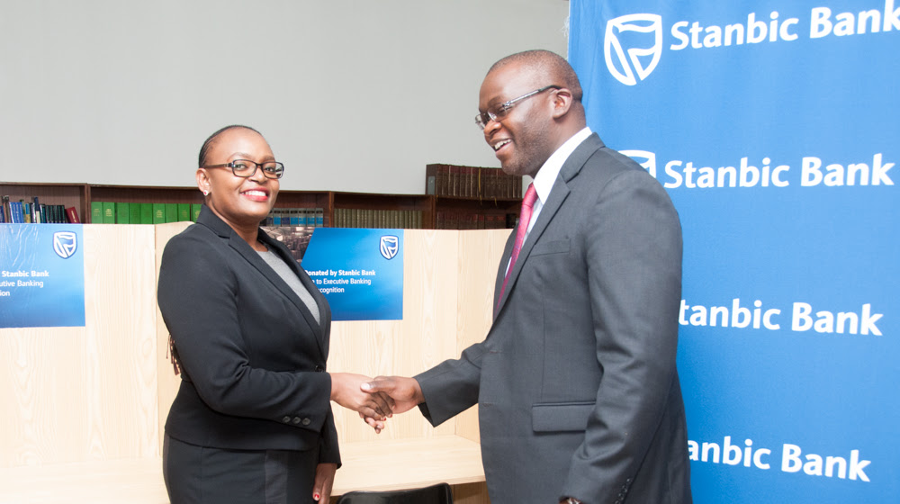 Stanbic Bank Zambia head legal and company secretary Doris Tembwe hands over new study cubicles to Attorney General Likando Kalaluka on behalf of Zambia Institute of Advanced Legal Education (ZIALE).