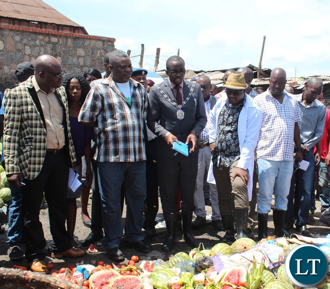 Kitwe District Commissioner, Chanda Kabwe (in hat) and Kitwe Mayor Christopher Kang’ombe during a tour of Chisokone Market to checked on the status of garbage.