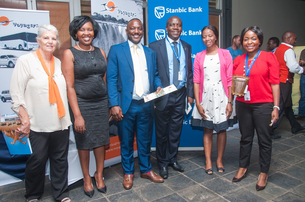 Stanbic Bank Zambia Chief Executive Charles Mudiwa, centre, and Head of Personal and Business Banking Mukandi Chibesakunda, second left, with Chichele Presidential Lodge prize winner Rodney Sikumba, Voyagers Manager Molly Care, Stanbic Public Relations and Communications Manager Chanda Chime-Katongo, right.
