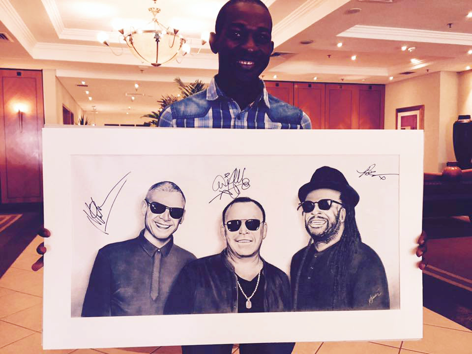 23-year-old Lusaka artist Silvester Mali with his drawing of UB40, being auctioned by Stanbic Bank to raise money for charity.