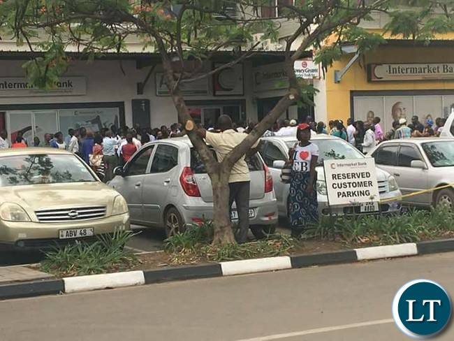 Customers line up outside Intermarket banking corporation branch at Farmers house
