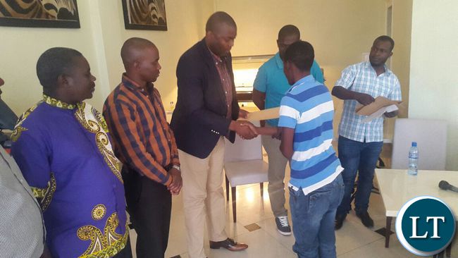 Copperbelt Minister Bowman Lusambo hands over scholarship to Charles Tembo