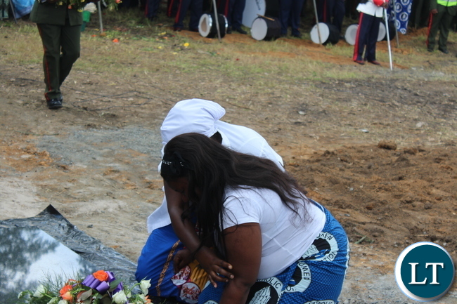 Late Ben Kapita's daughter Patricia being counselled by a family member
