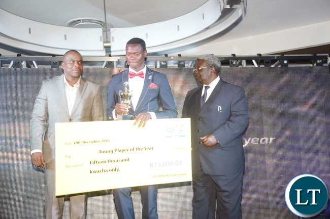 MTN Zambia Chief Technical Officer Thomas Motlepa, Power Dynamos striker Patson Daka, National Sport Council of Zambia Chairman Mwama Kalenga during during a cheque prize presentation of the "2016 FAZ/ MTN league Young Player of the year" to the winner.