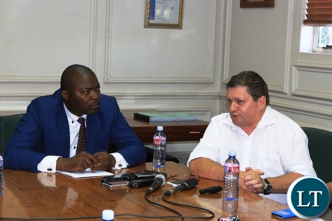 Copperbelt Province Minister, Bowman Lusambo, listens to Mopani Copper Mines Chief Executive Officer, Johan Jansen, in Kitwe