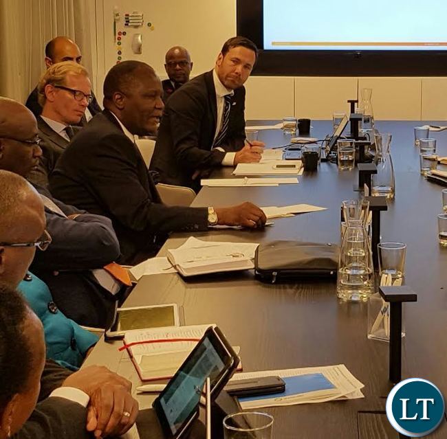 Finance Minister Felix Mutati addressing highly powered meeting of investors in Stockholm as Swedish ambassador to Zambia Henrik Cederine and Charge de Affaires Anthony Mukwita follow discussion. Business Sweden have invited all blue chip financiers to be present.