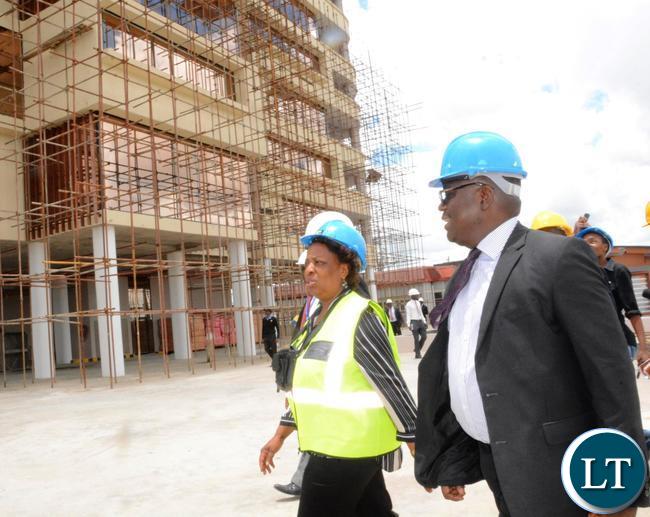 Minister of Labour Joyce Simukoko (in yellow reflector) flanked by Zambia National building Society Managing Director Joseph Chikolwa (r) touring the construction site of office at Society Business Park in Lusaka