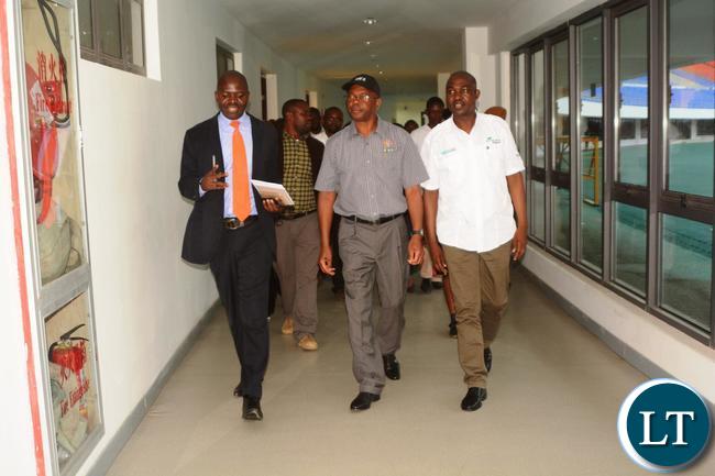 Minister of Works and Supply Mathew Nkhuwa(c),Lusaka Province Minister Japhen Mwakalombe(r) and Ministry of Housing and Infrastructure Development Structural Engineer Francis Mundanya(l) during the tour of Infrastructure at Heroes Stadium