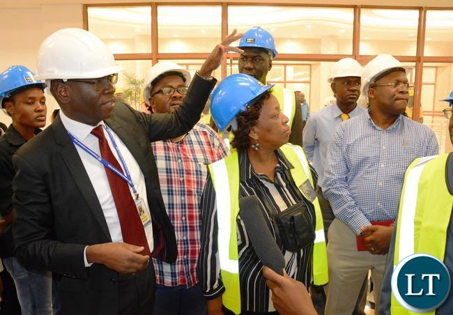 National pension Scheme Authority Director General Yollard Kachinda showing the (NPSA) offices to Minister of Labour Joyce Simukoko during the tour of Society Business Park in Lusaka