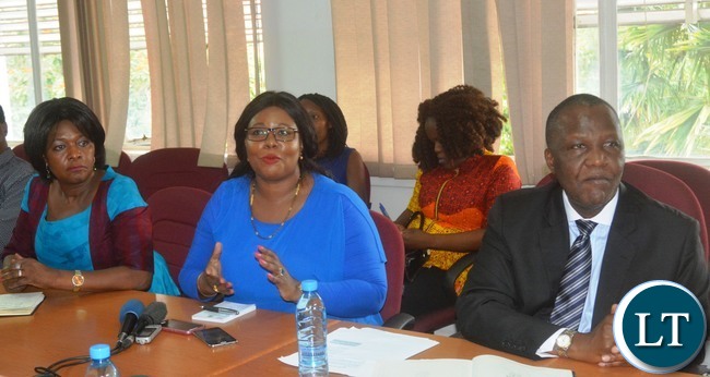 Minister of Agriculture Dora Siliya(c) speaking during a Press Briefing while Minister of Finance Felix Mutati(r) and Commerce Minster Margaret Mwanakatwe(l) looks on at the Ministry of Finance