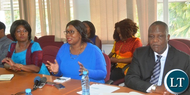 Minister of Agriculture Dora Siliya(c) speaking during a Press Briefing while Minister of Finance Felix Mutati(r) and Commerce Minster Margaret Mwanakatwe(l) looks on at the Ministry of Finance