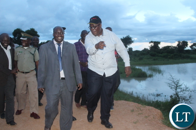 Southern Province Minister Dr Edify Hamukale and the provincial permanent secretary Mr. Sibanze Simuchoba inspecting the Munyenze Dam (right) in Bana Kaili ward of Monze District