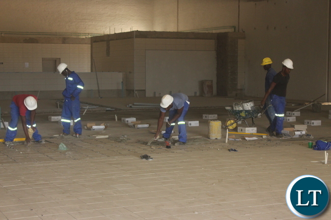 Workers tiling the floors at the US$ 7 Million Shopping Mall in Kabwe.Pictures By Kelvin Tembo-ZANIS.?