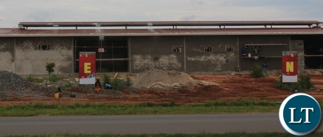 MEI MEI- Owners of Dolla Hill Mall on the Ndola-Kitwe Dual Carriage way have defied government's directive to stop the construction of a structure which is on the bufferzone of the Dual Carriage way. Here workers doing final touches to the strucure whose construction was stopped when it was at foundation level