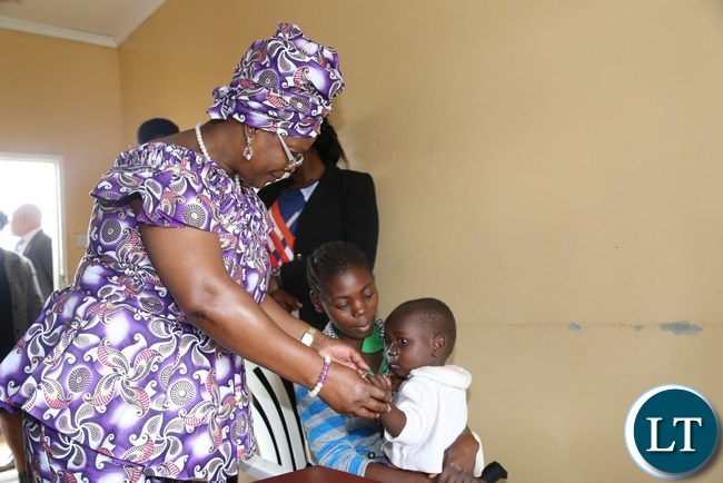First Lady Esther Lungu admires a baby at a Health Centre during a tour and hand over of food hampers to beneficiaries of Misissi Health Outreach Center at St.Lawrence Parish in Kamwala South.