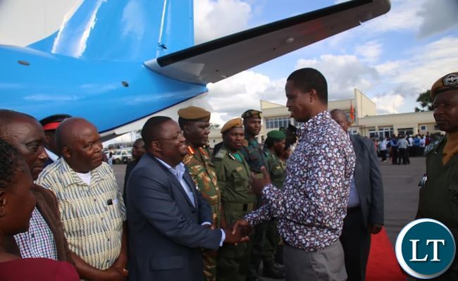 PRESIDENT Edgar Lungu confers with Luapula Province Permanent Secretary Dr. Buleti Nsemukila at Mansa airport shortly before departure for Lusaka. This was after the President concluded his tour of the province