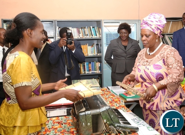 Zambia Institute of Special Education Music Lecturer Janet Kapepelesha(l) explaining to the First Lady Esther Lungu(r) the use of the Music Instrument as the First Lady Toured the School Library at Zambia Institute of Special Education yesterday,3-3-2017, Picture by Ennie Kishiki/Zanis.