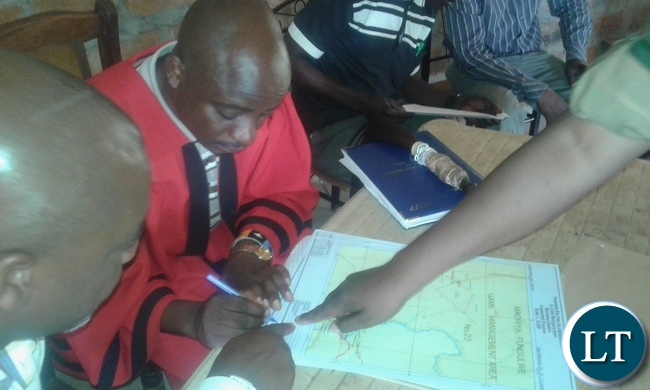 Chief Machiya of the Lamba speaking people in Mpongwe signs a consent giving the zambia army access to 2000 hecters for cultivation purposes. picture by Keith Maila.