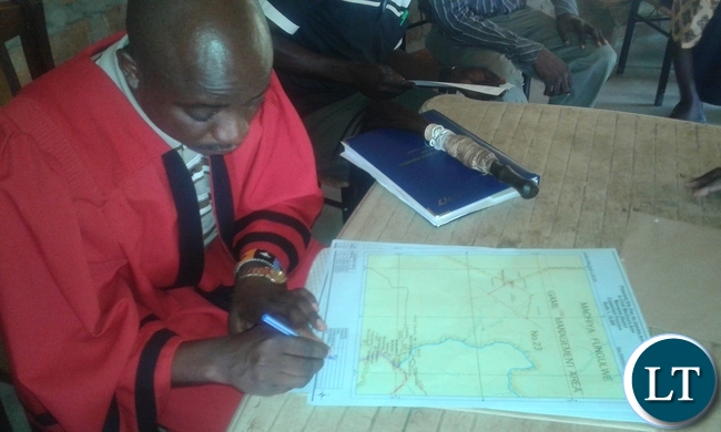 Chief Machiya of the Lamba speaking people in Mpongwe signs a consent giving the zambia army access to 2000 hecters for cultivation purposes. picture by Keith Maila.