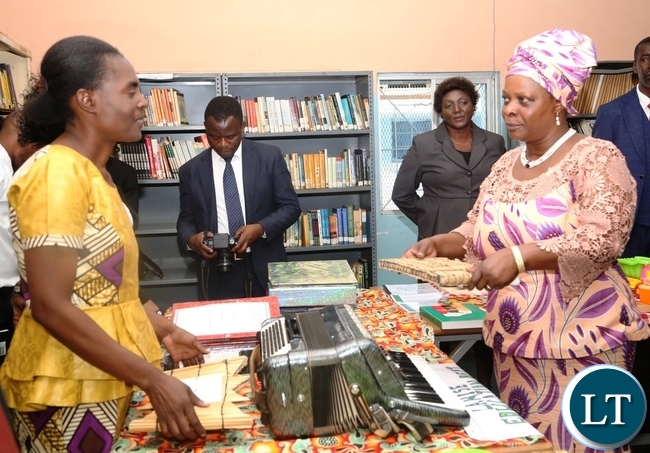 Zambia Institute of Special Education Music Lecturer Janet Kapepelesha(l) explaining to the First Lady Esther Lungu(r) the use of the Music Instrument as the First Lady Toured the School Library at Zambia Institute of Special Education yesterday,3-3-2017, Picture by Ennie Kishiki/Zanis.