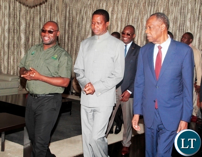 Youth and Sports Minister chats with President Edgar Lungu (c) CAF President Issa Hayatou (r) at State House