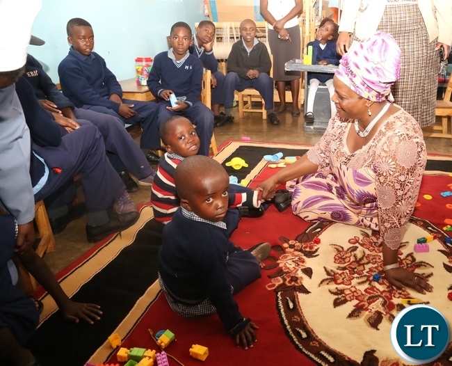 First Lady Esther Lungu(in chitenge suit) having a light moment with Disabled children as she visited Zambia Institute of Special Education in Lusaka yesterday,3-3-2017, Picture by Ennie Kishiki/Zanis.