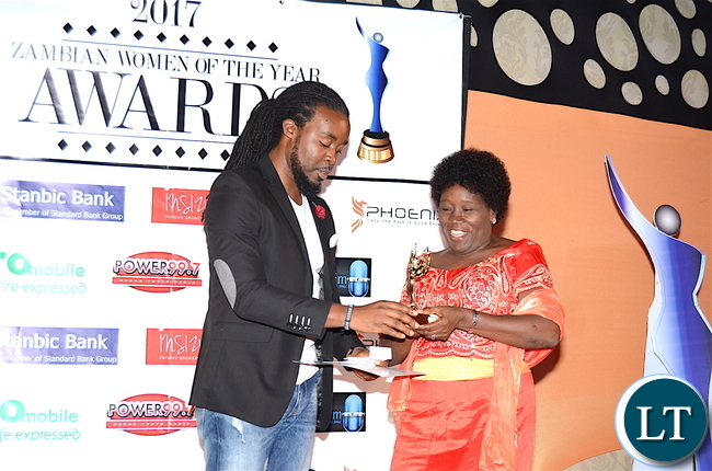 Ken Tonga presents the Cultural Ambassadors award to Judith Mwila during the Afro Multi Media Productions Women of the Year Awards giving Ceremony to mark the International Women's Day Celebrations at Government Complex in Lusaka on Tuesday, March 7,2017 -Picture by THOMAS NSAMA