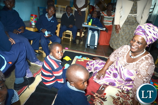 First Lady Esther Lungu interacts with physically challenged children at Zambia Institute of Special Education where she flagged off the International Women's Day activities under the theme: Promoting inclusiveness in economic participation as a means of attending sustainable development on Friday, March 3,2017 -Pictures by THOMAS NSAMA