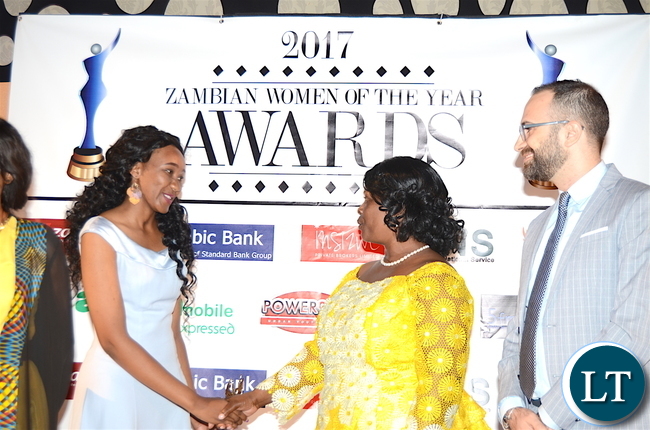 First Lady Esther Lungu congratulates First Female Fighter Pilot Thokozile Muwamba for scooping the Woman of the Year award during the Afro Multi Media Productions Women of the Year Awards giving Ceremony to mark the International Women's Day Celebrations at Government Complex in Lusaka on Tuesday, March 7,2017 -Picture by THOMAS NSAMA
