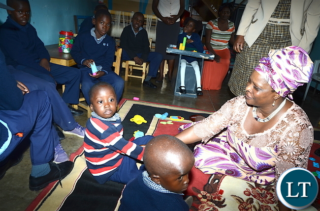 First Lady Esther Lungu interacts with physically challenged children at Zambia Institute of Special Education where she flagged off the International Women's Day activities under the theme: Promoting inclusiveness in economic participation as a means of attending sustainable development on Friday, March 3,2017 -Pictures by THOMAS NSAMA