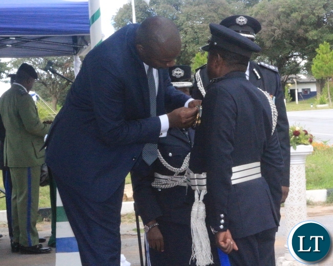 Copperbelt Minister, Bowman Lusambo unveiling medals given to deserving Police Officers during 'Police Day' at Kamfinsa School of Meintenance in Kitwe Copperbelt Minister, Bowman Lusambo unveiling medals given to deserving Police Officers during 'Police Day' at Kamfinsa School of Meintenance in Kitwe